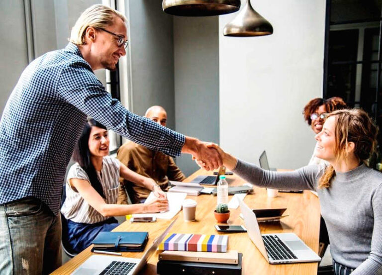 man-and-woman-shaking-hands-in-meeting