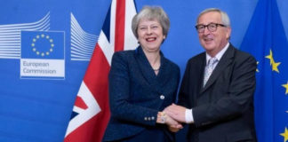 Theresa May shakes hands with EU chief Jean-Claude Juncker after agreeing the deal